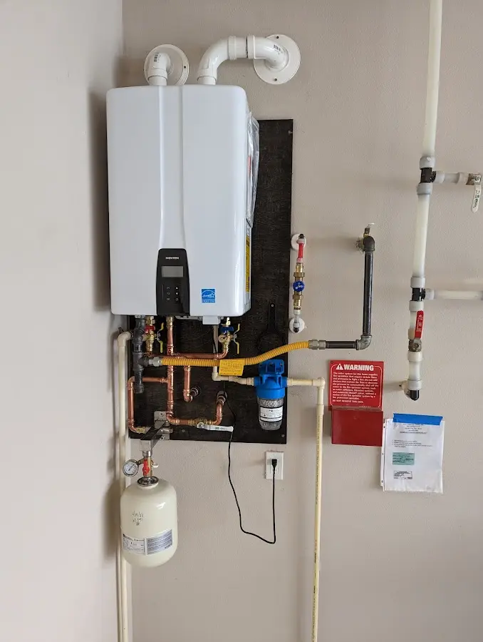 Professional plumber installing copper piping in a Cody home